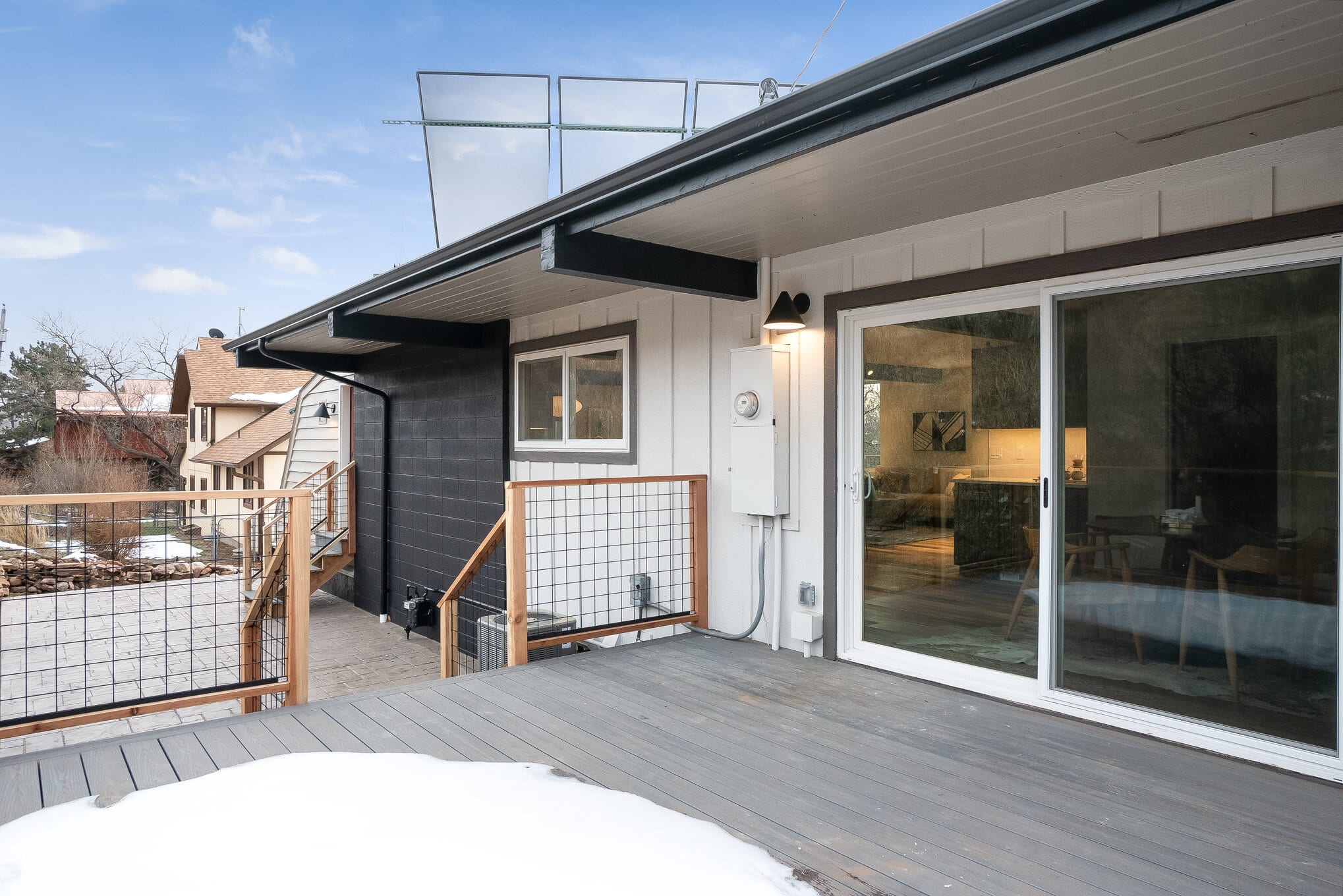 View from the back deck of a modern home with wood and metal railings