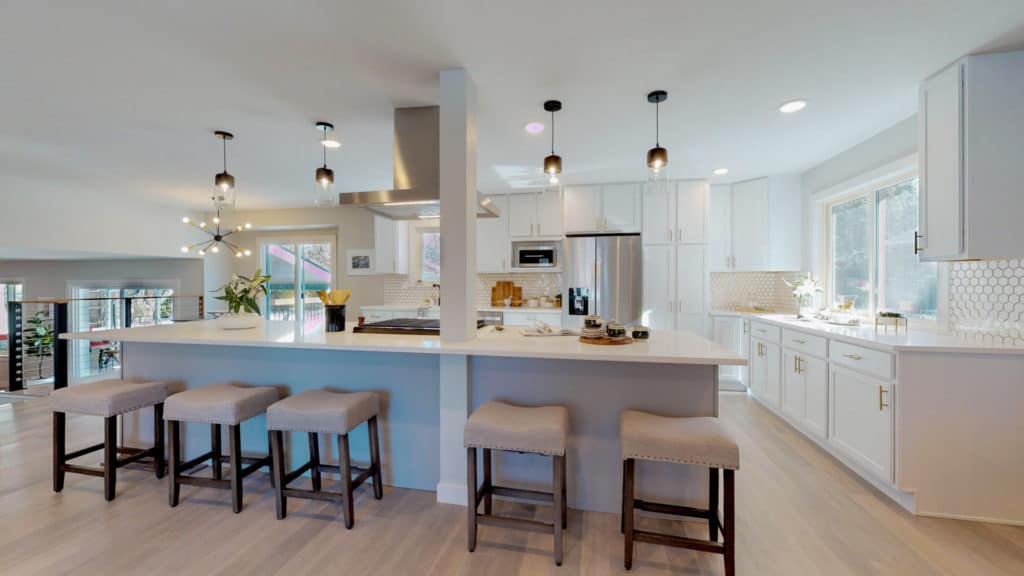Modern kitchen with large breakfast bar and five brown stools