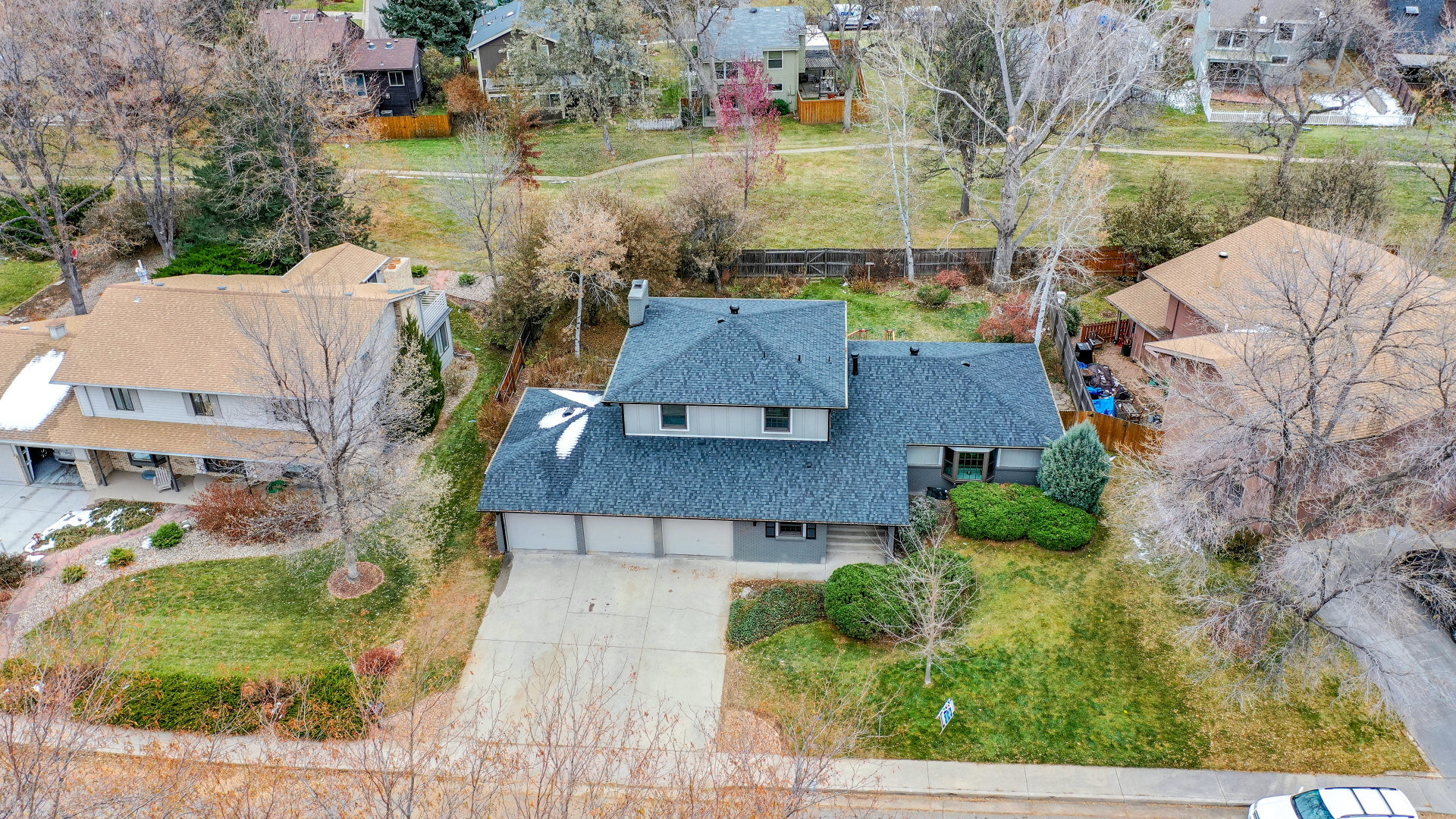 Aerial view of a large home with bay window and three garages