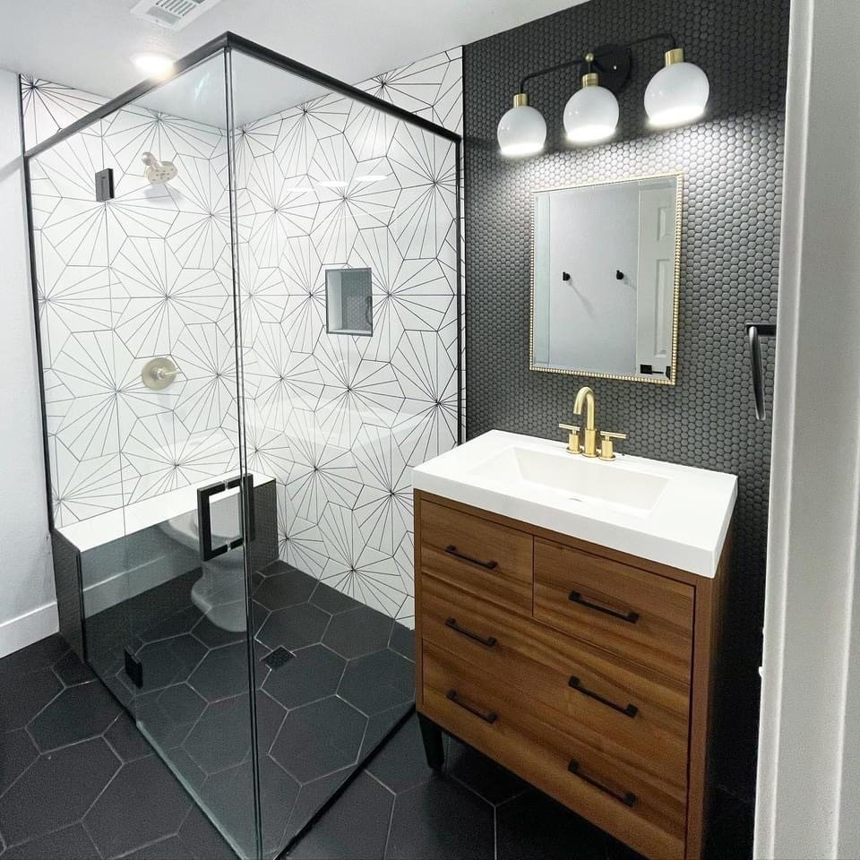 Black and white bathroom with modern wooden vanity and large walk-in shower