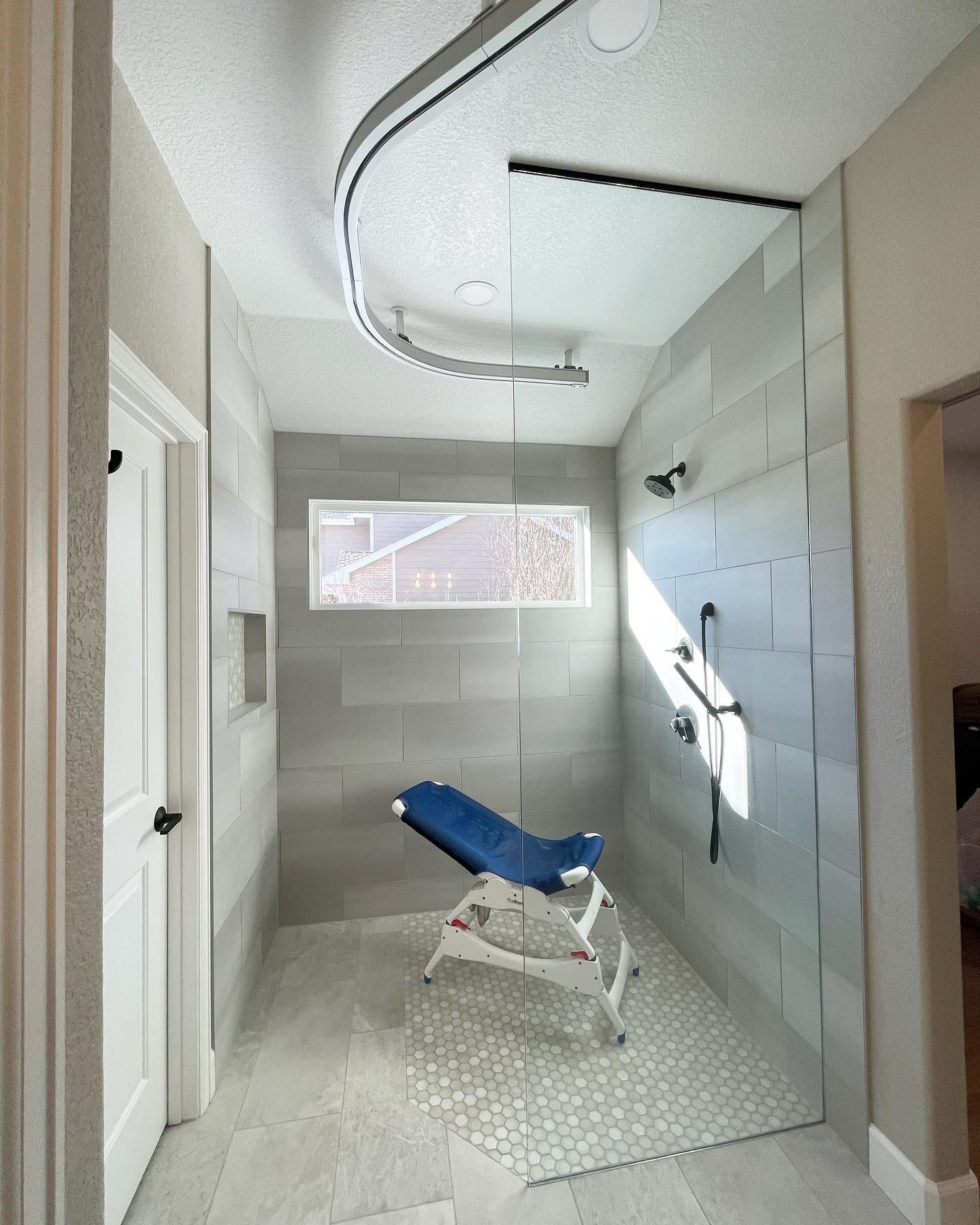 Custom walk-in shower with mobility aid built in