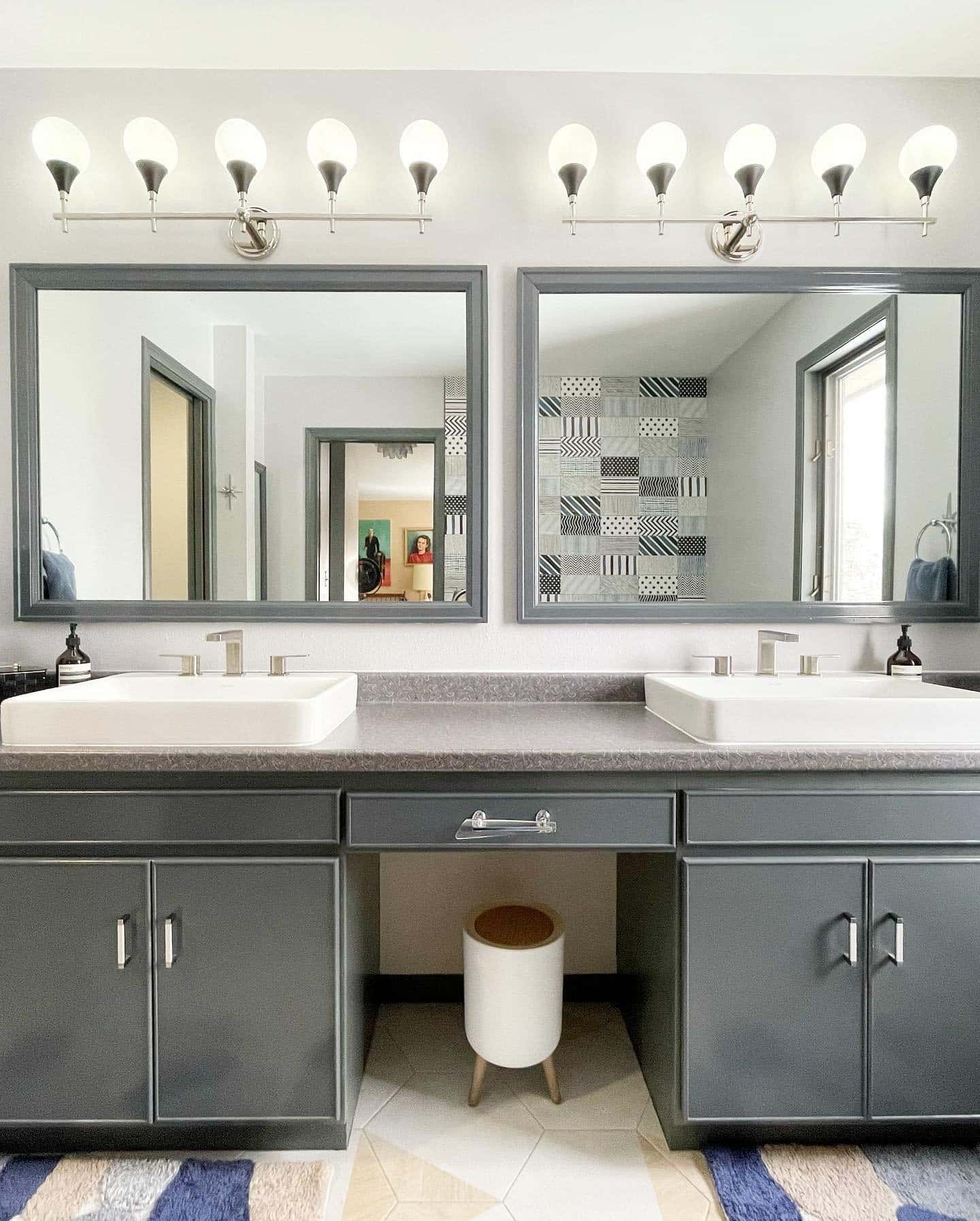 Gray double vanity with bright lighting and large mirrorrs