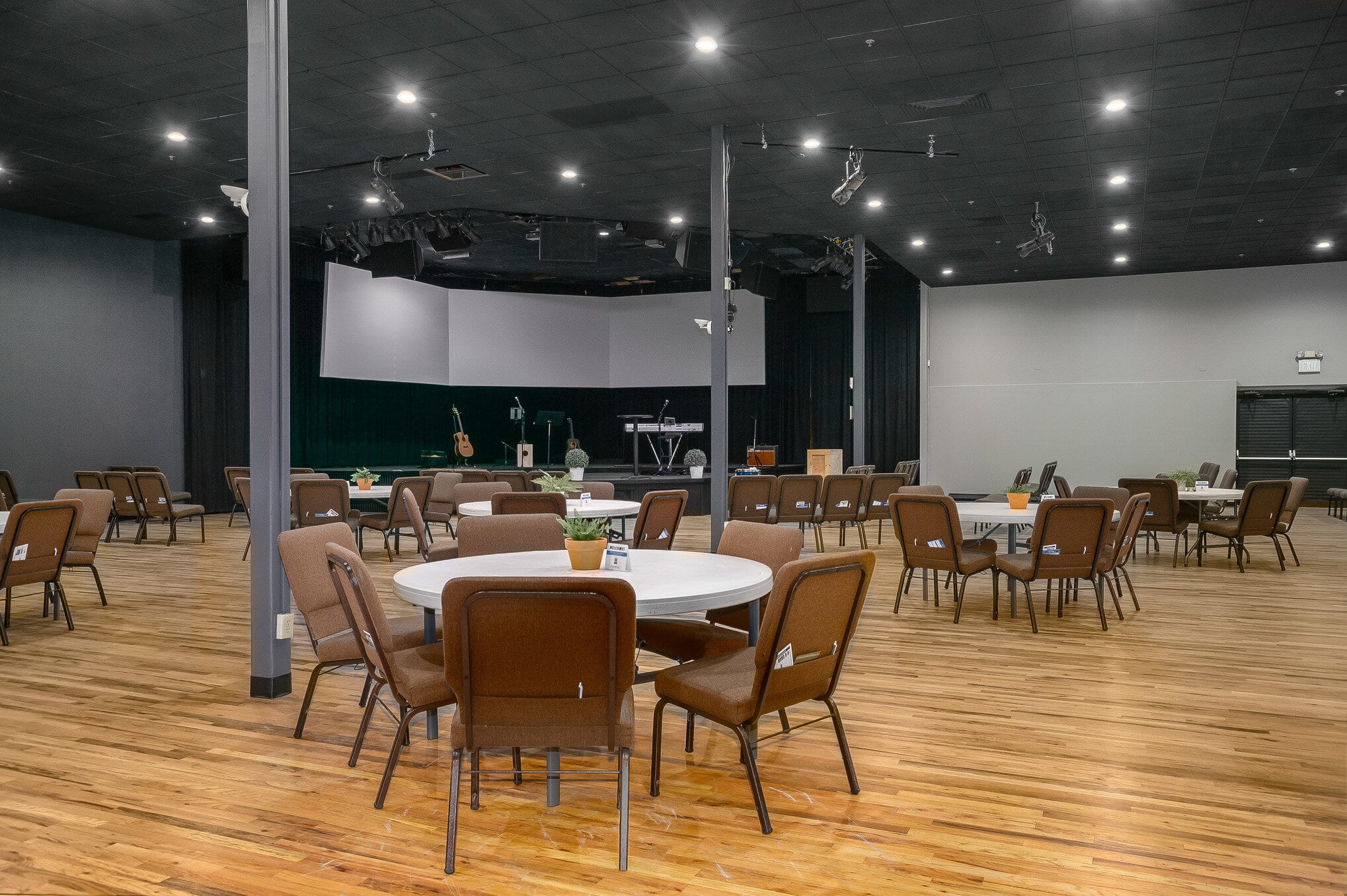 Large banquet hall with stage and round tables