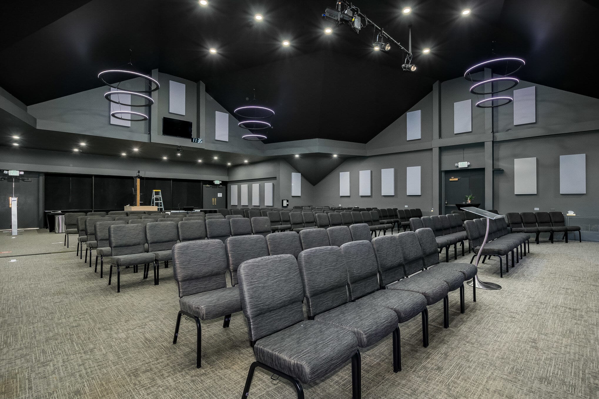Seating in an auditorium with colorful lights and geometric decor