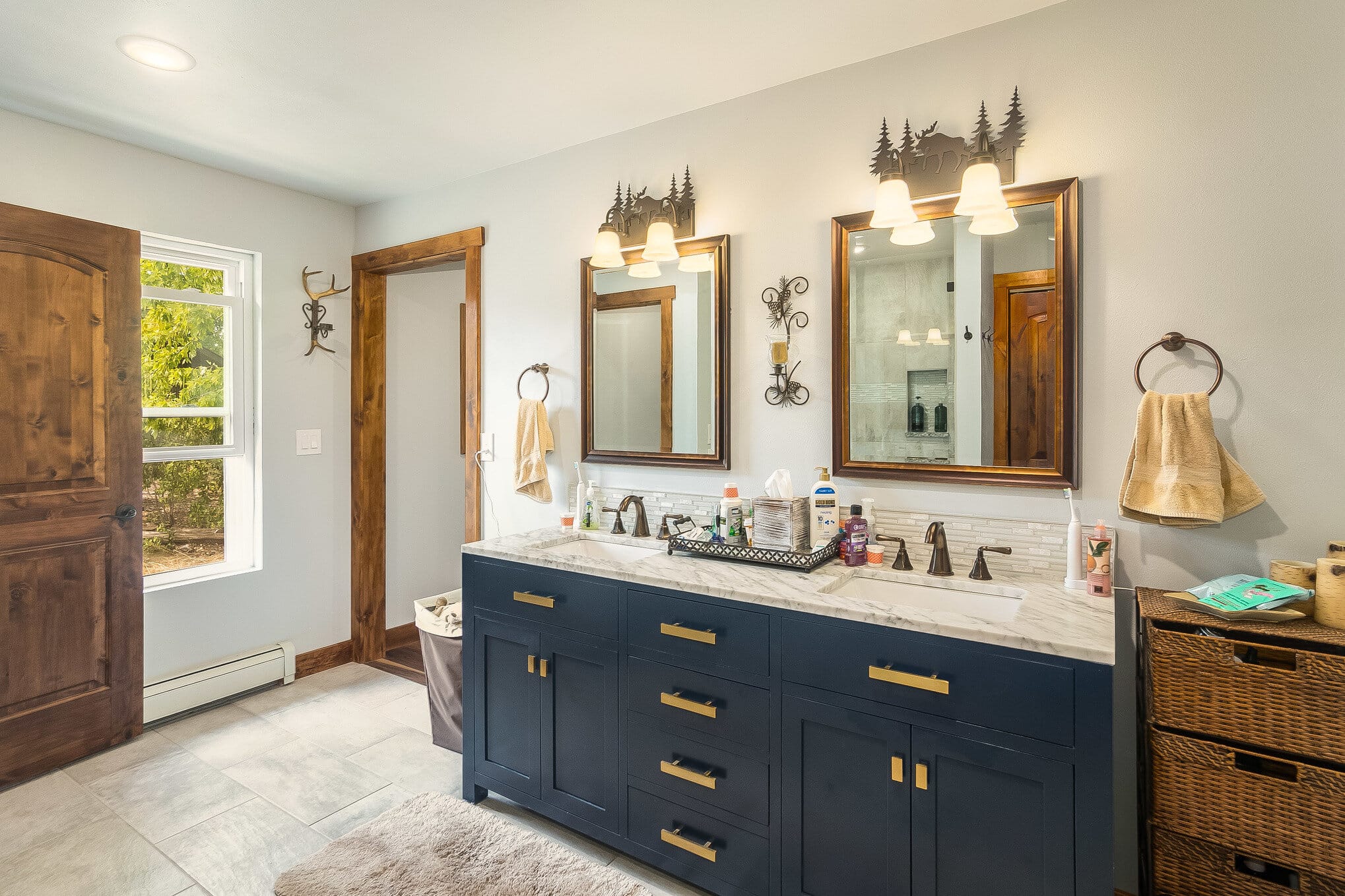 Double bathroom vanity with navy blue cabinets and white marble countertop
