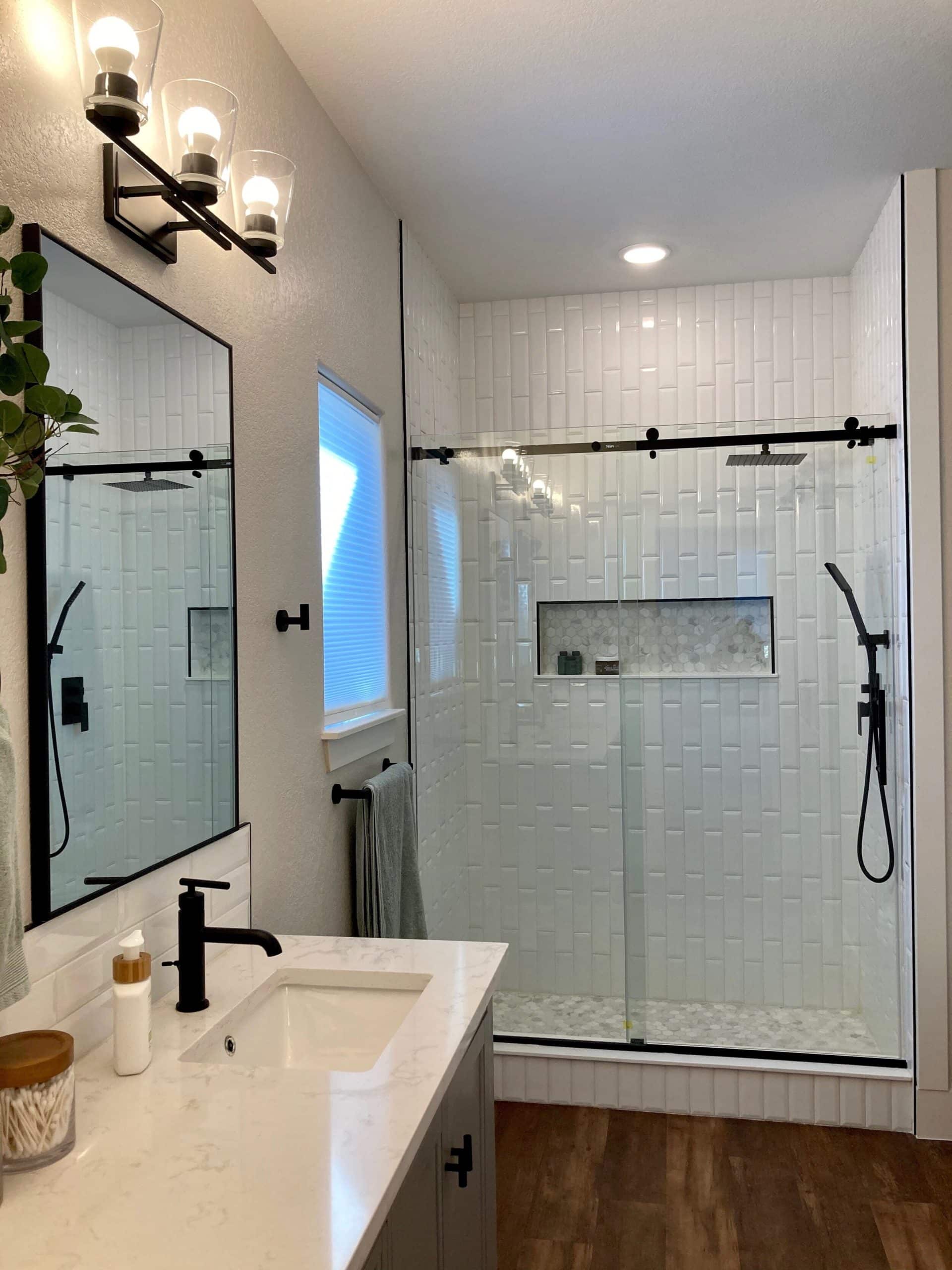Bathroom with white tile and black trim