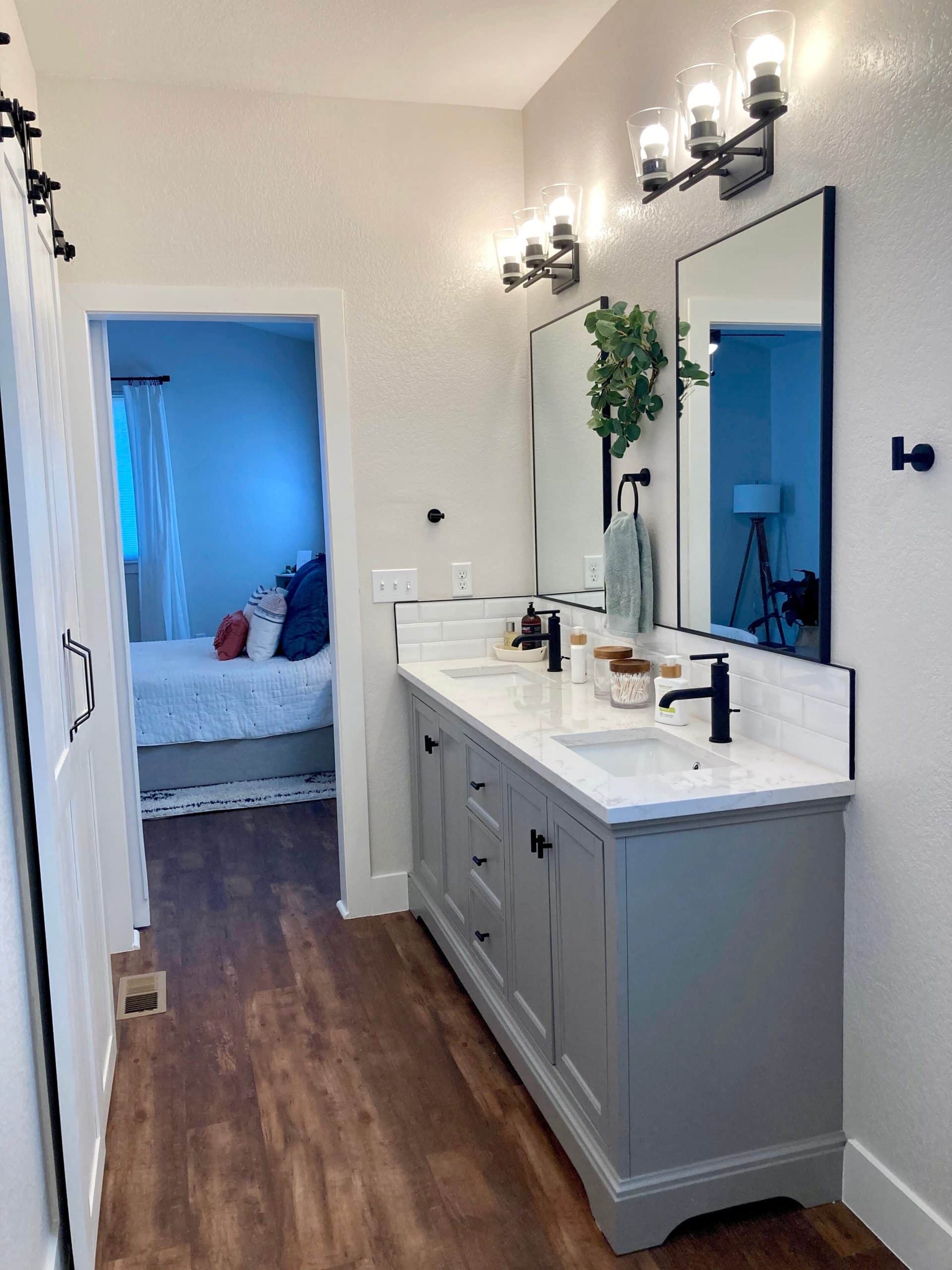 Double bathroom vanity with gray cabinets and white counter top