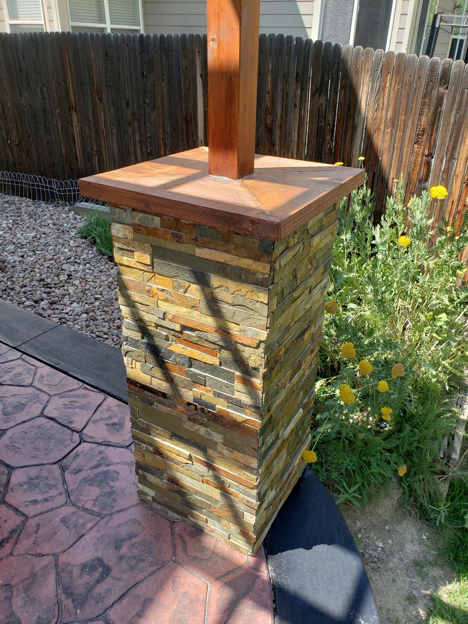 Wood and stone outdoor support pillar on a covered patio