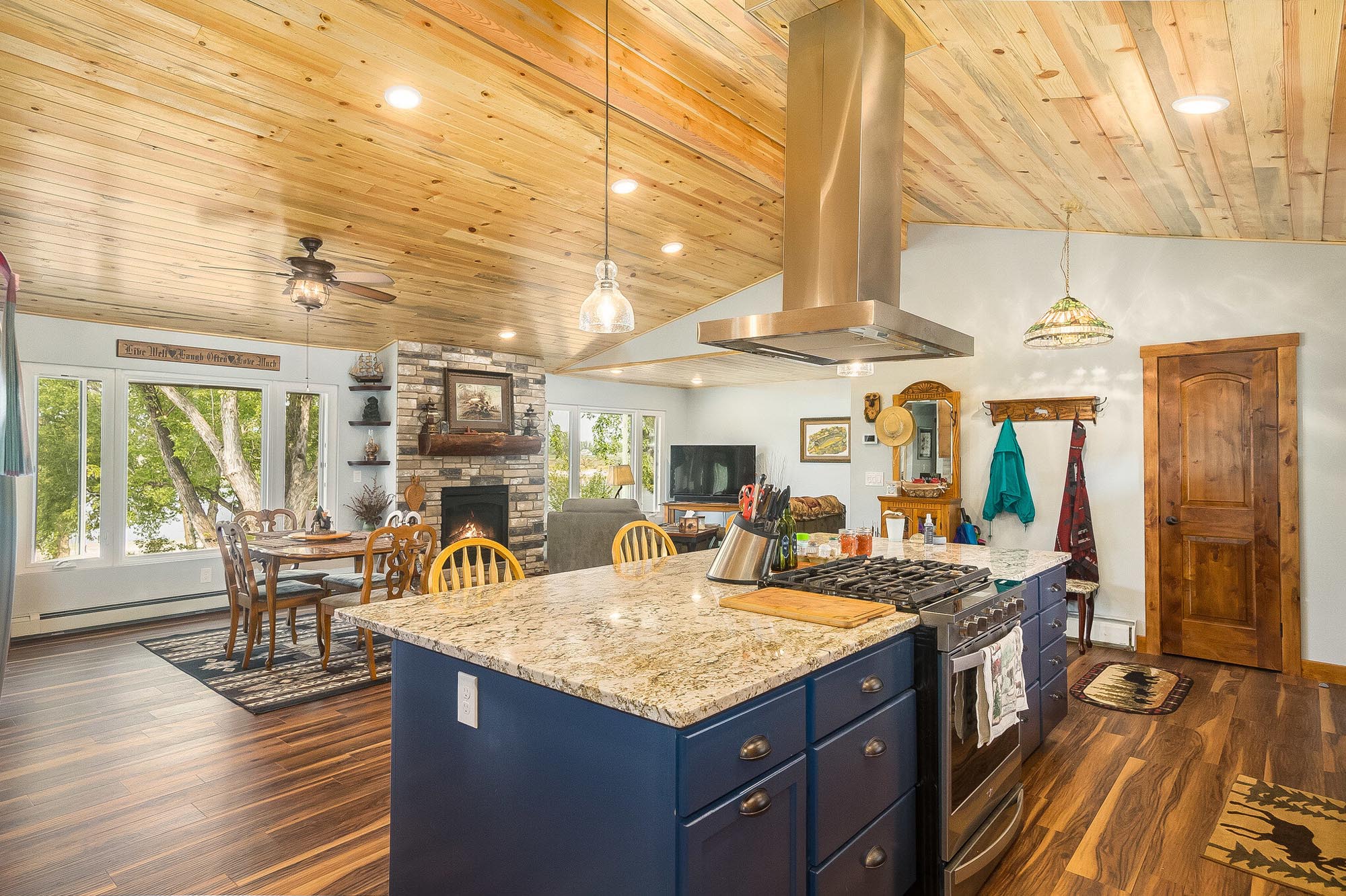 Rustic style kitchen with wooden ceiling and dark blue cabinets